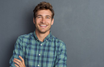 young handsome man in a checkered shirt smiling